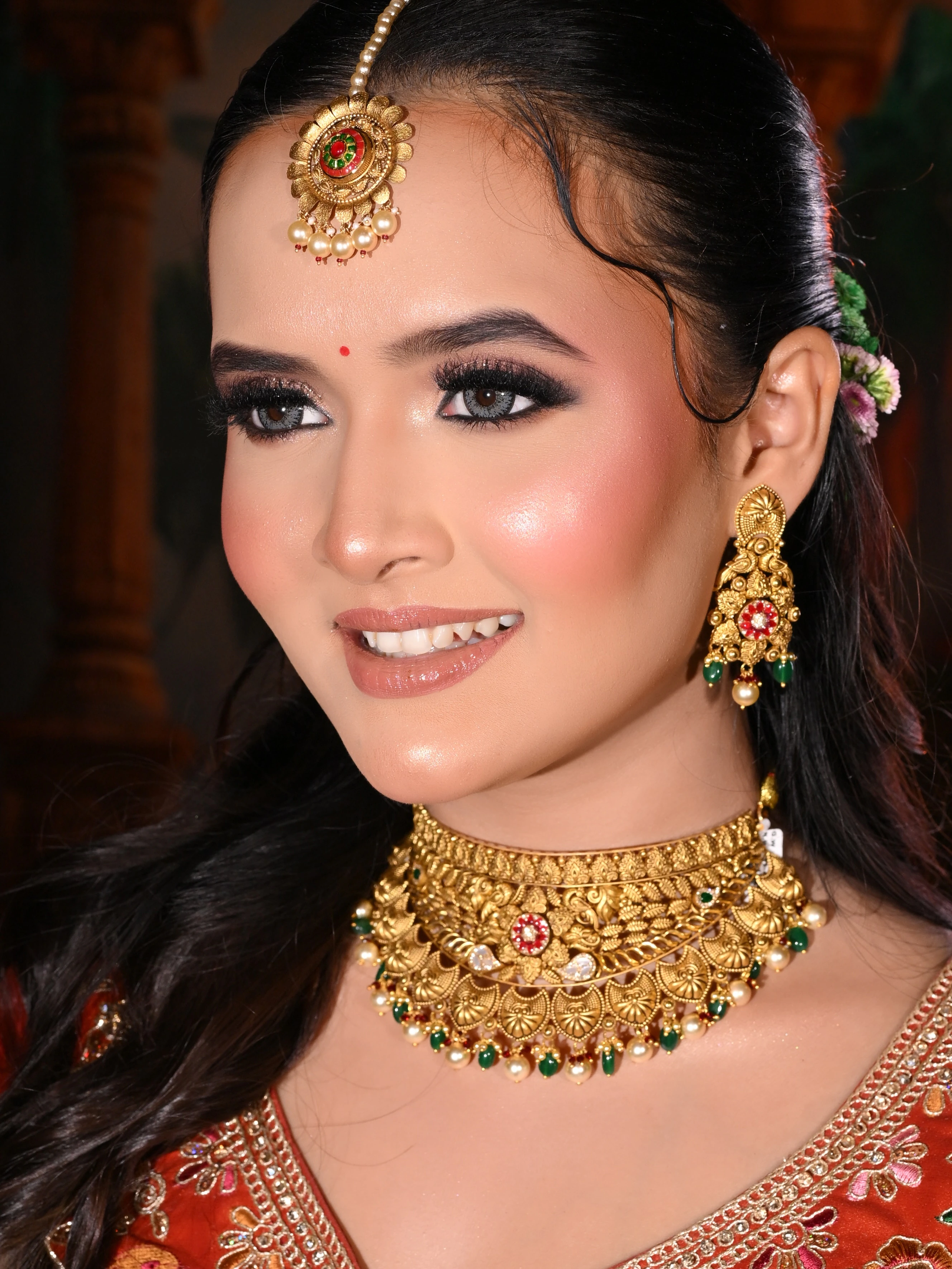 Bride wearing a temple gold choker and earrings